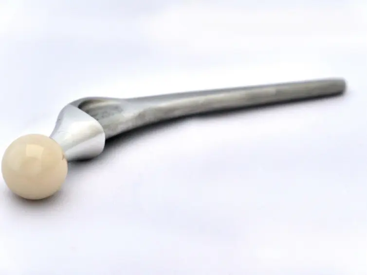 A picture of an artificial hip in metal.