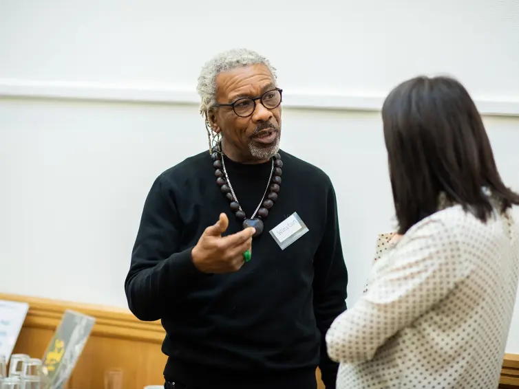 Two people talking at event.
