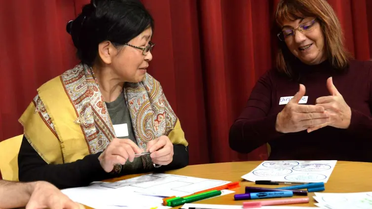 Person communicating to second person using sign language.