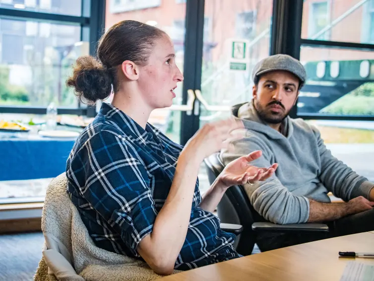 Two people sitting at a table.